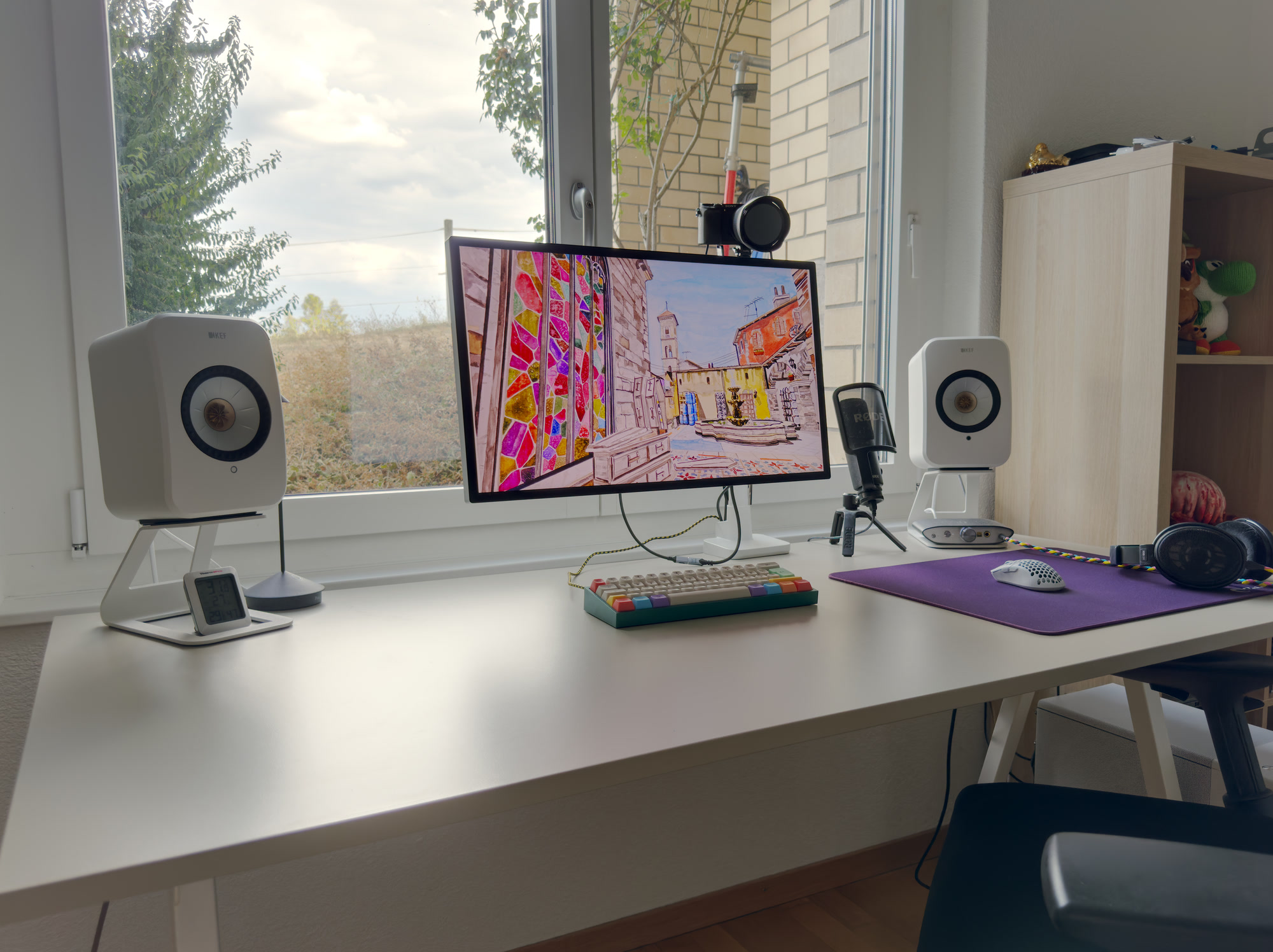 Computer setup in front of a window.
