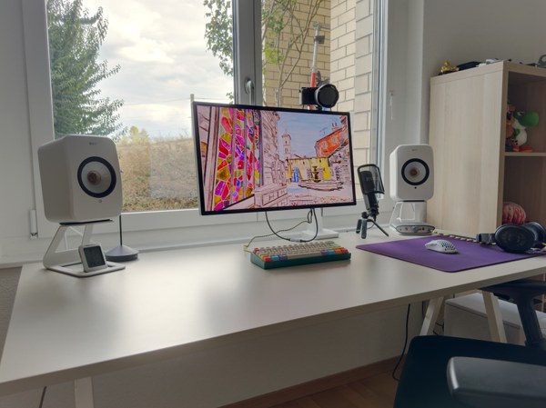 Computer setup in front of a window.