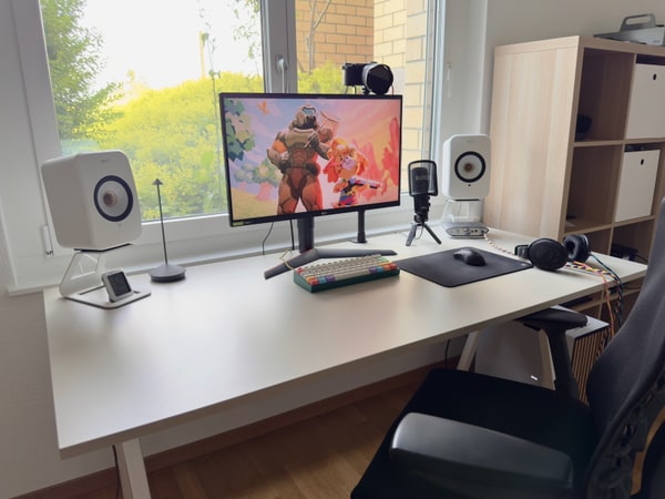 Computer setup in front of a window.