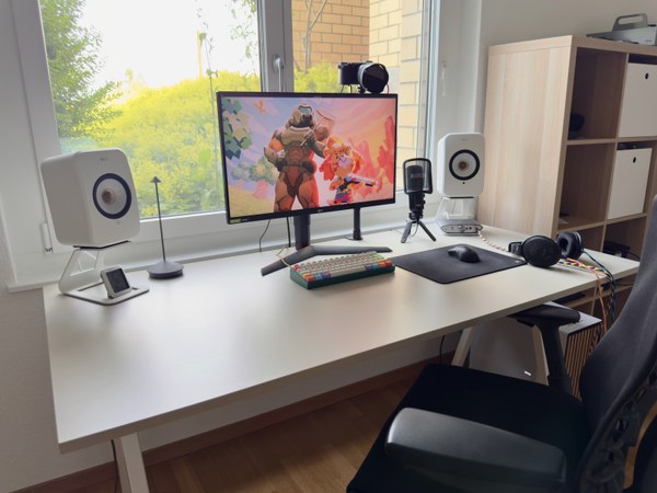 Computer setup in front of a window.